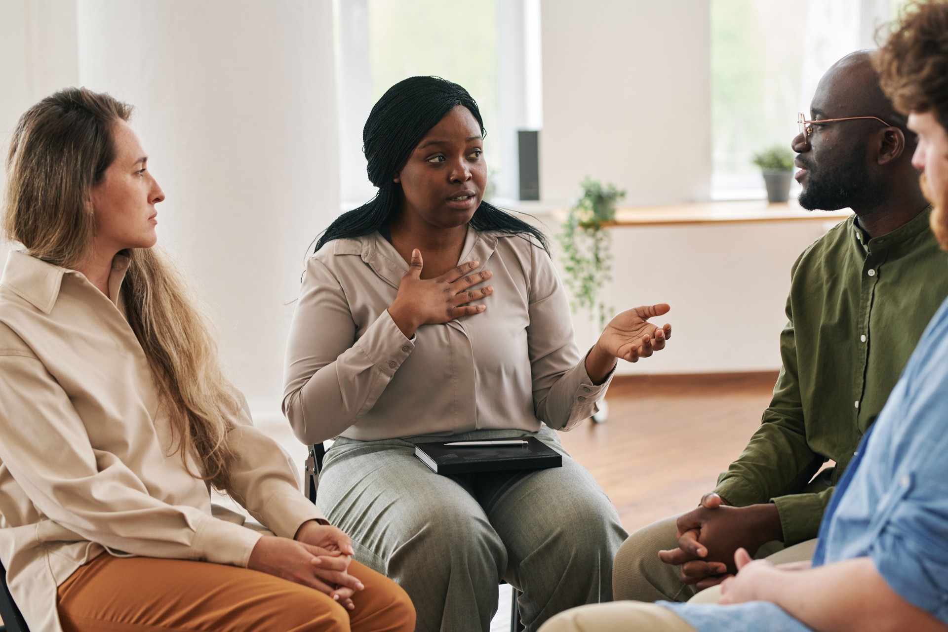 Confident black woman describing her mental problem or worries at session
